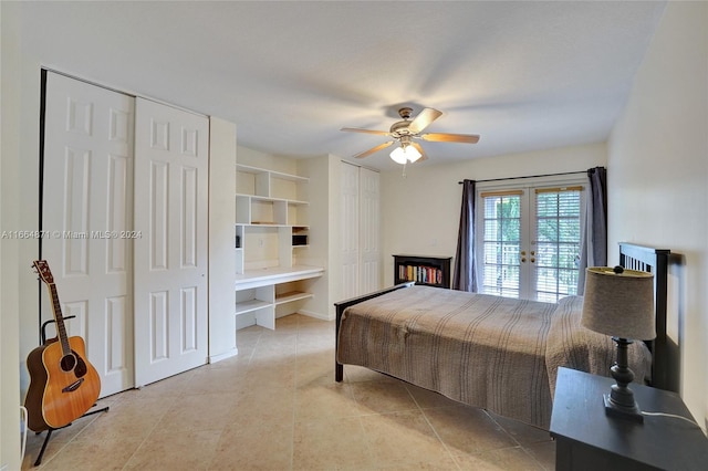 tiled bedroom featuring french doors, multiple closets, and ceiling fan