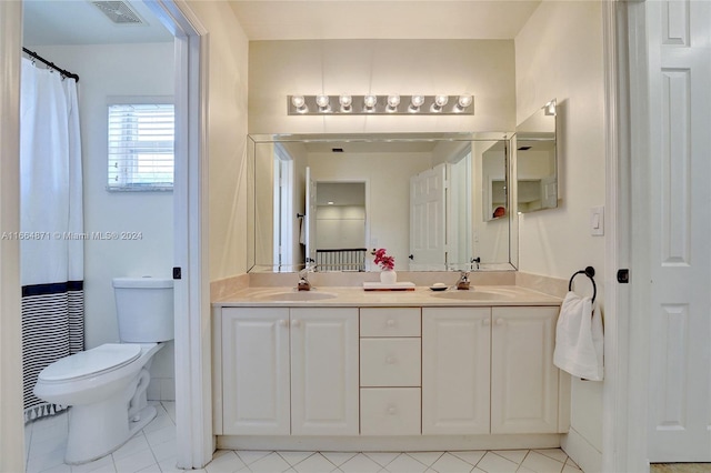 bathroom with vanity, toilet, and tile patterned flooring