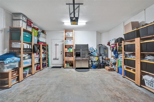 garage featuring a garage door opener and stainless steel refrigerator with ice dispenser