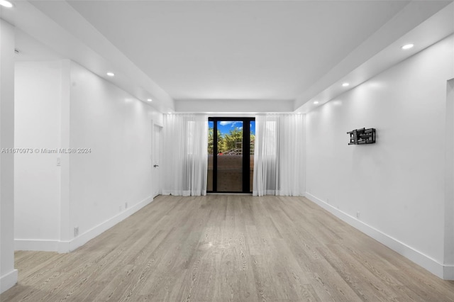 empty room with light hardwood / wood-style flooring