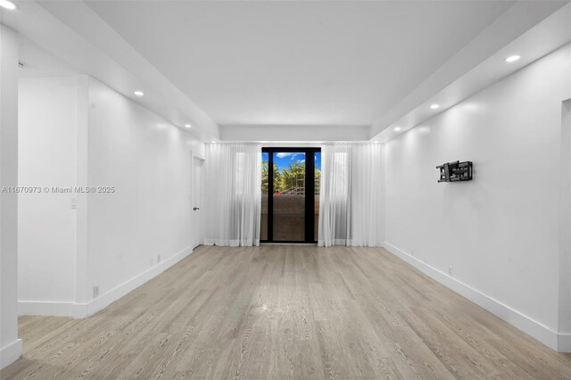 kitchen with white cabinetry, stainless steel appliances, and light wood-type flooring