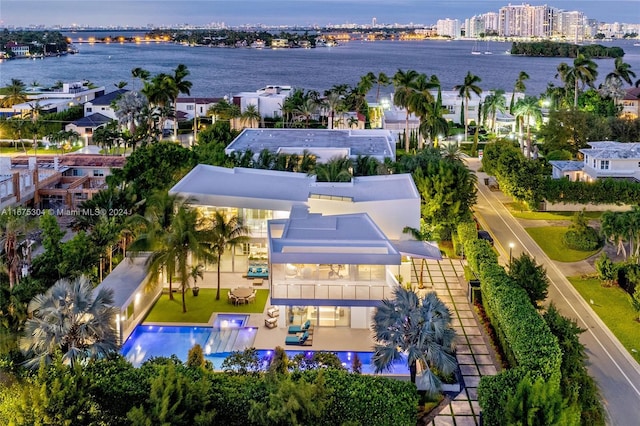 birds eye view of property with a water view