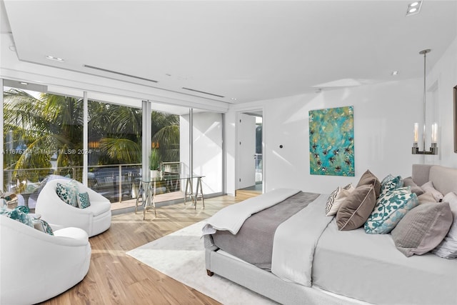 bedroom with access to outside and wood-type flooring