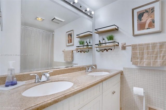 bathroom featuring vanity and curtained shower