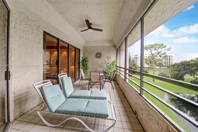 unfurnished sunroom featuring ceiling fan