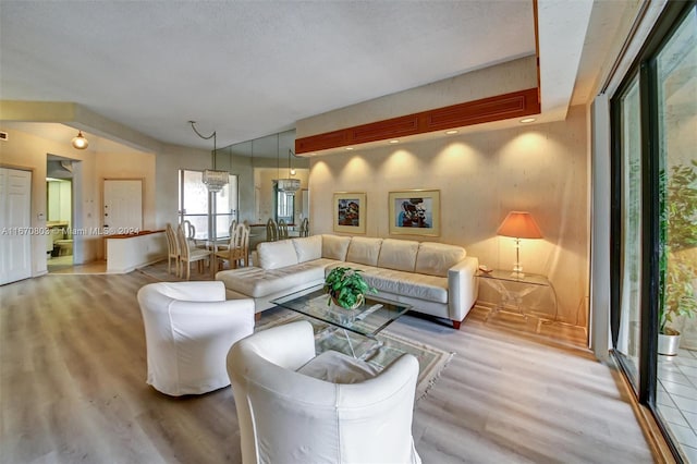 living room with a textured ceiling and light wood-type flooring