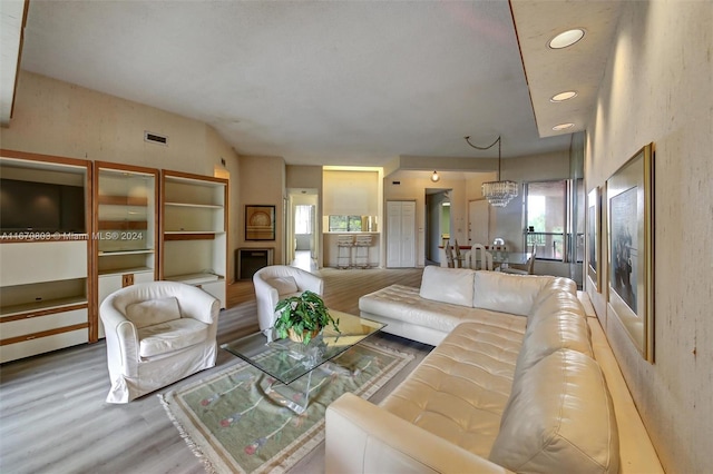 living room featuring a chandelier and hardwood / wood-style flooring