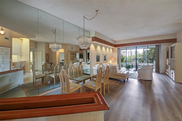 unfurnished dining area with dark wood-type flooring and an inviting chandelier