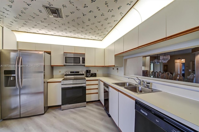 kitchen featuring sink, light hardwood / wood-style floors, and appliances with stainless steel finishes