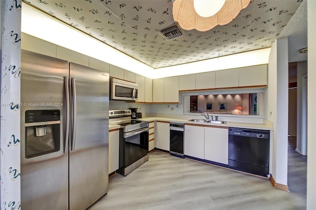 kitchen with sink, light wood-type flooring, and appliances with stainless steel finishes