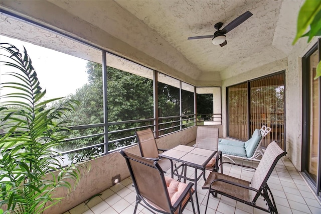 sunroom / solarium featuring plenty of natural light and ceiling fan