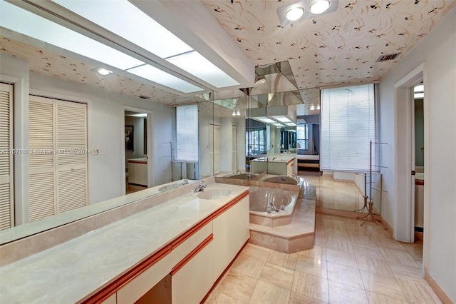 bathroom featuring a bath and vanity