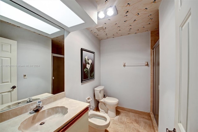 bathroom with vanity, toilet, an enclosed shower, and a bidet