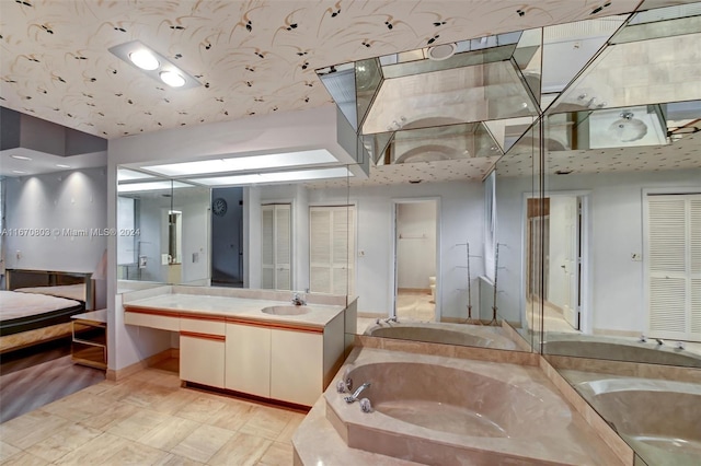 bathroom featuring a tub to relax in and vanity