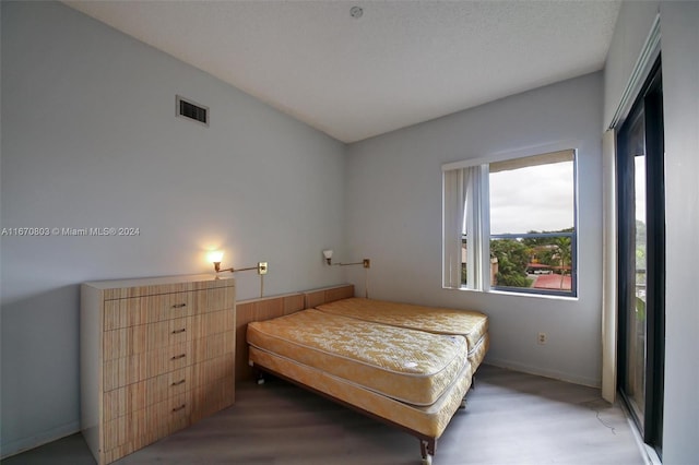 bedroom featuring dark hardwood / wood-style flooring and a textured ceiling