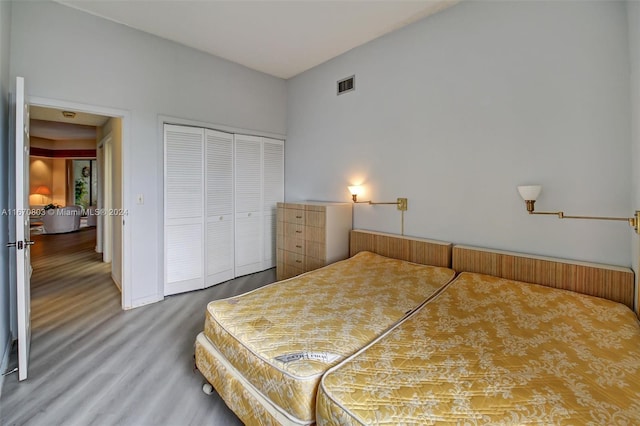 bedroom with wood-type flooring and a closet