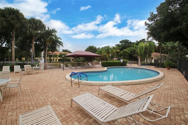 view of swimming pool with a gazebo and a patio