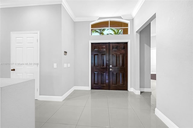 tiled foyer featuring crown molding