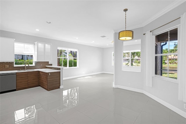 kitchen featuring sink, decorative light fixtures, stainless steel dishwasher, ornamental molding, and decorative backsplash