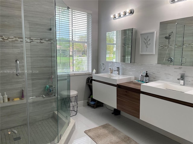 bathroom with tasteful backsplash, walk in shower, tile patterned flooring, and vanity