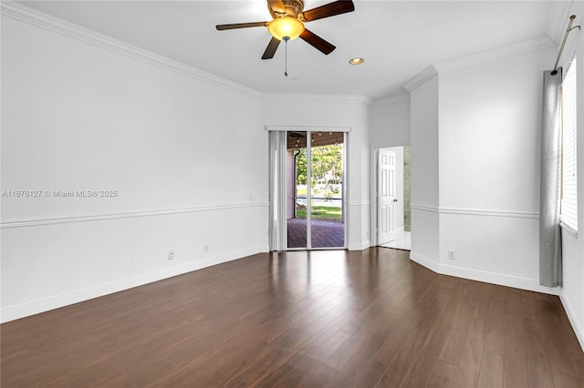 empty room featuring crown molding, dark wood-type flooring, and ceiling fan