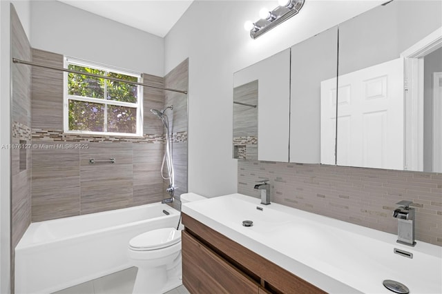 full bathroom featuring vanity, backsplash, tiled shower / bath combo, and toilet