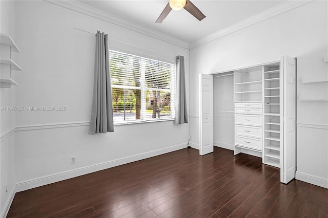 unfurnished bedroom with ornamental molding, dark hardwood / wood-style floors, ceiling fan, and a closet