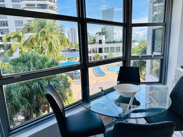 sunroom with a water view and a healthy amount of sunlight