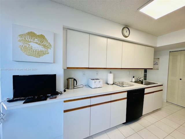 kitchen featuring dishwasher, sink, white cabinetry, light tile patterned floors, and a textured ceiling