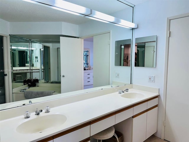 bathroom featuring vanity and a textured ceiling