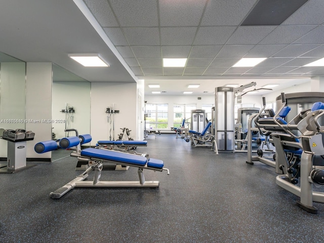 gym with a paneled ceiling