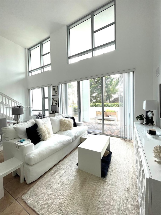 tiled living room with a high ceiling