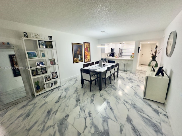 dining room featuring a textured ceiling