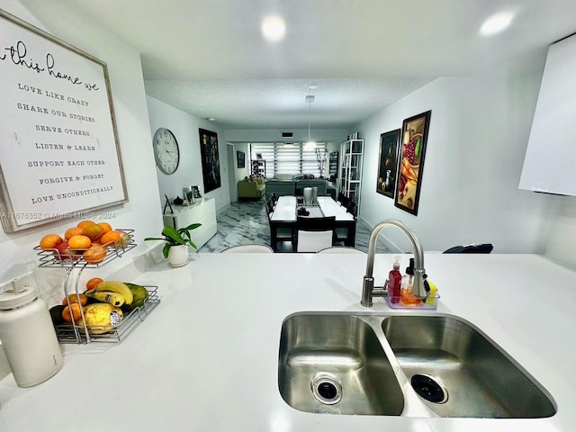 kitchen featuring sink and a textured ceiling