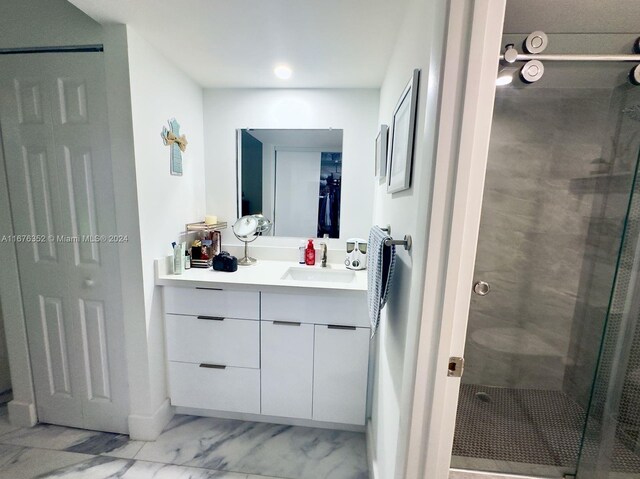 bathroom featuring vanity and a shower with shower door