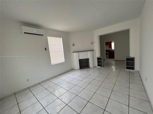 unfurnished living room featuring light tile patterned flooring and a wall mounted AC