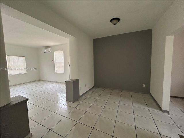 tiled empty room with a wealth of natural light and a wall mounted AC