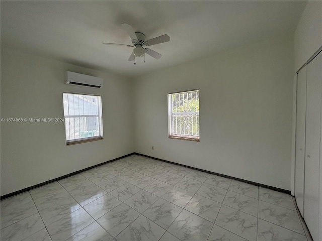 unfurnished room with plenty of natural light, a wall unit AC, and ceiling fan