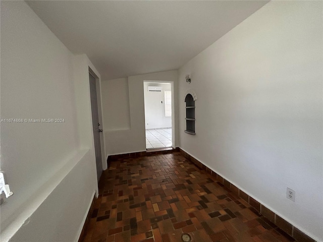 hall featuring lofted ceiling