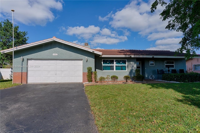 ranch-style house with a front yard and a garage