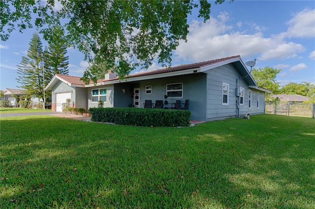 view of front of property with a garage and a front yard