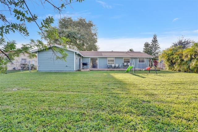 rear view of property featuring a yard