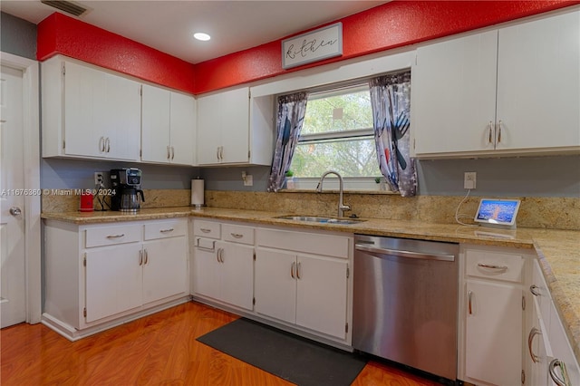 kitchen featuring light hardwood / wood-style flooring, white cabinets, sink, and stainless steel dishwasher