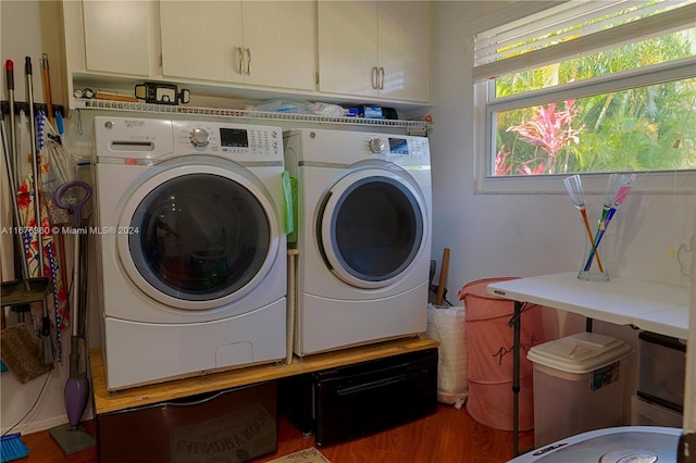 washroom featuring separate washer and dryer, cabinets, and hardwood / wood-style flooring