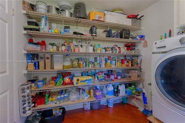 laundry room featuring hardwood / wood-style flooring, a textured ceiling, and washer / dryer