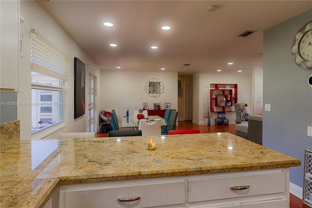 kitchen featuring wood-type flooring and white cabinets