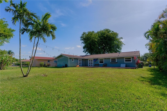 back of property with a lawn