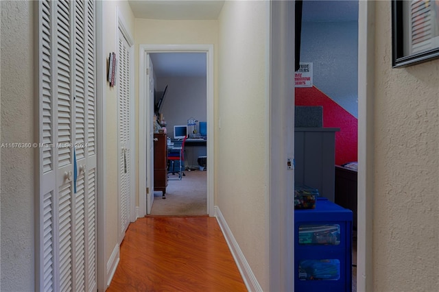 corridor featuring wood-type flooring