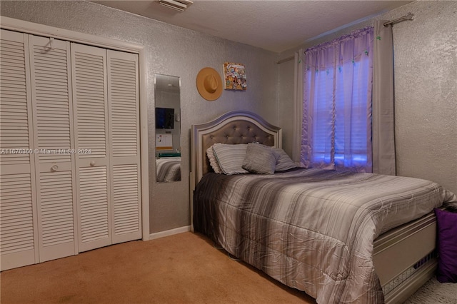 bedroom with light carpet, a textured ceiling, and a closet