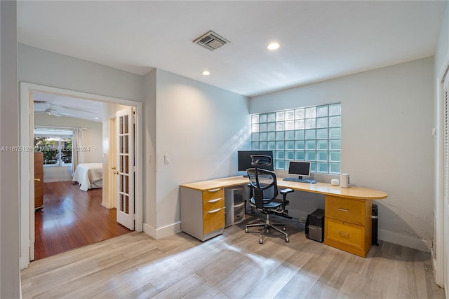 office space featuring ceiling fan and light hardwood / wood-style flooring